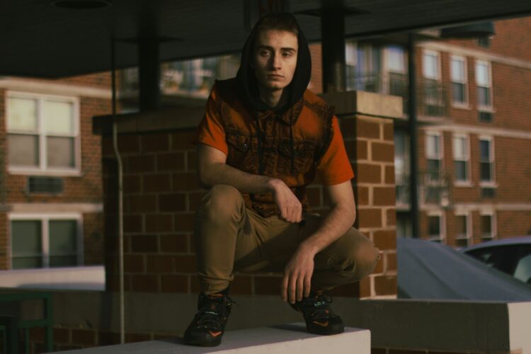 A man sitting on top of a white box