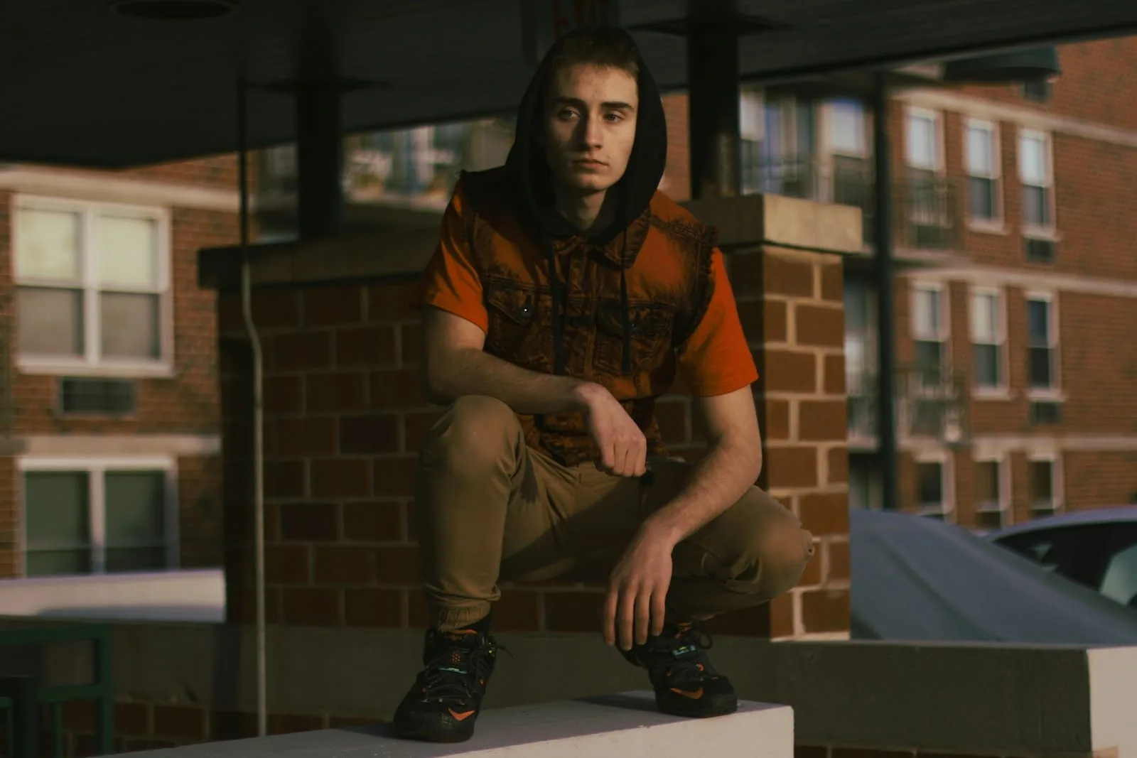 A man sitting on top of a white box